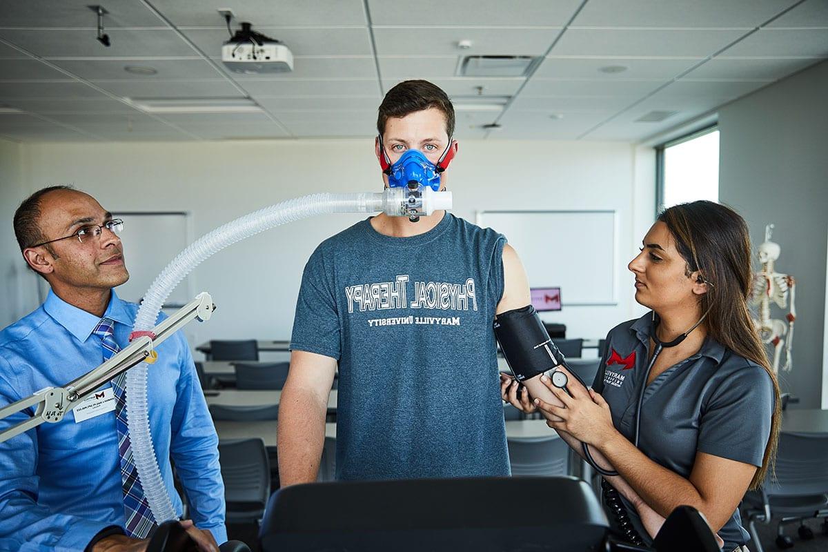 Physical therapy student learning in lab